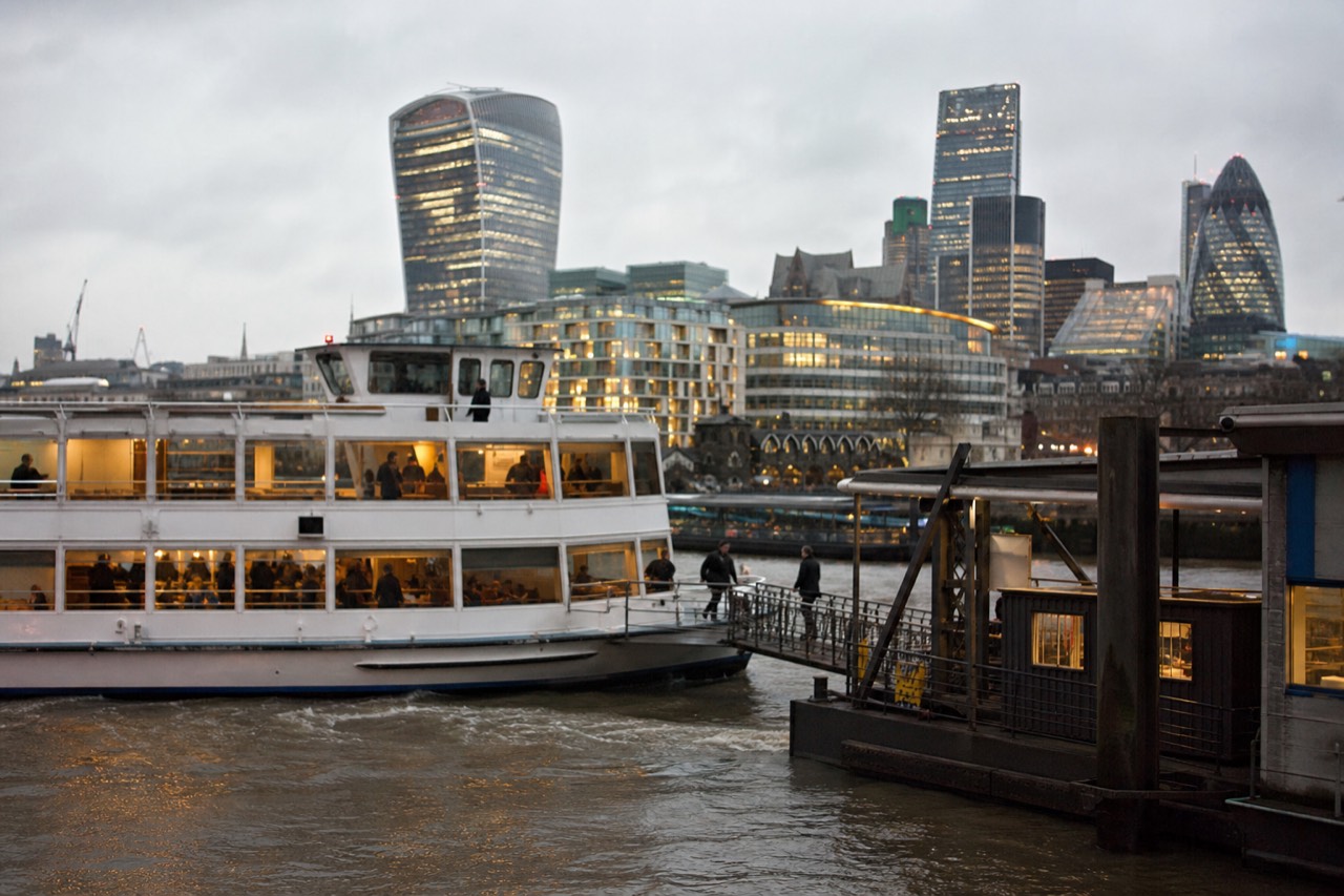 Passengers boarding a river boat at a central London pier