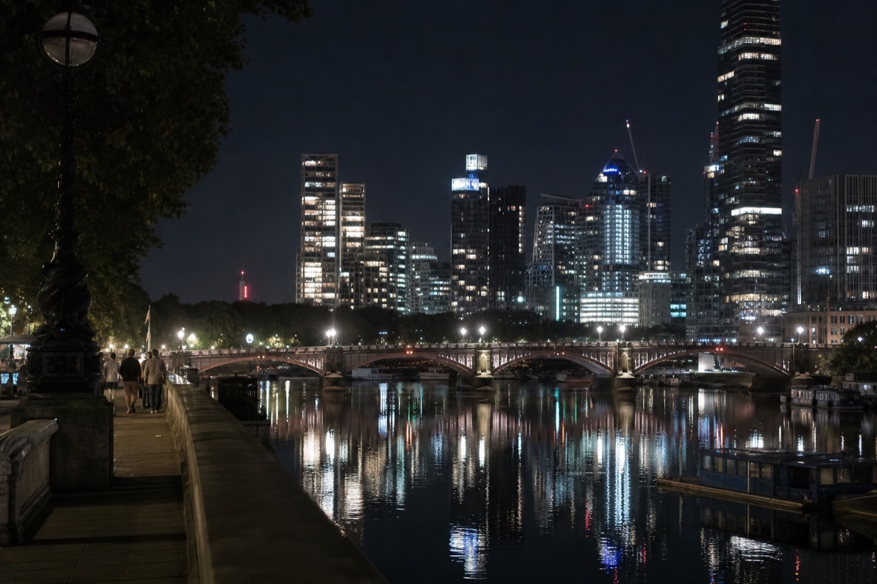 Evening cruise boat on the Thames with the city lights reflected on the water