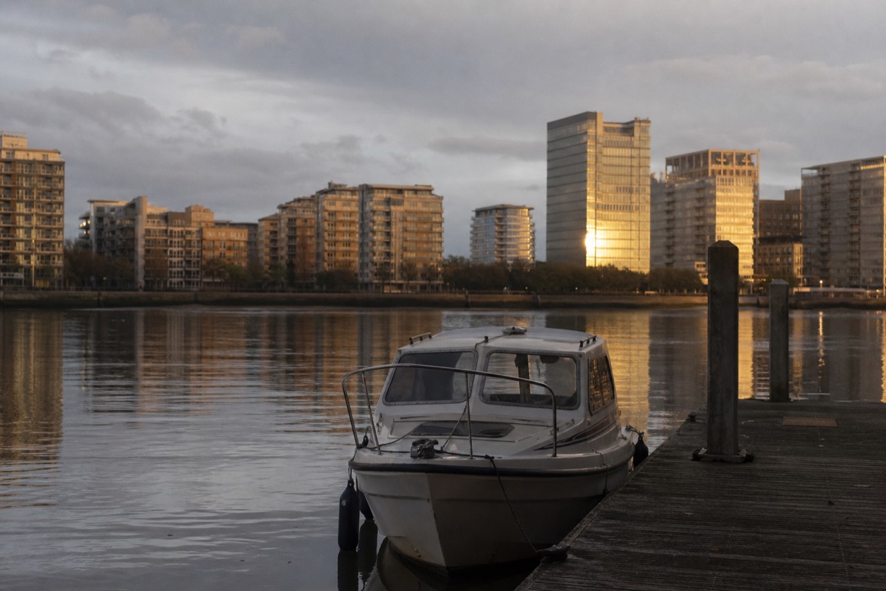 Private boat with skipper waiting at a quiet Thames pier