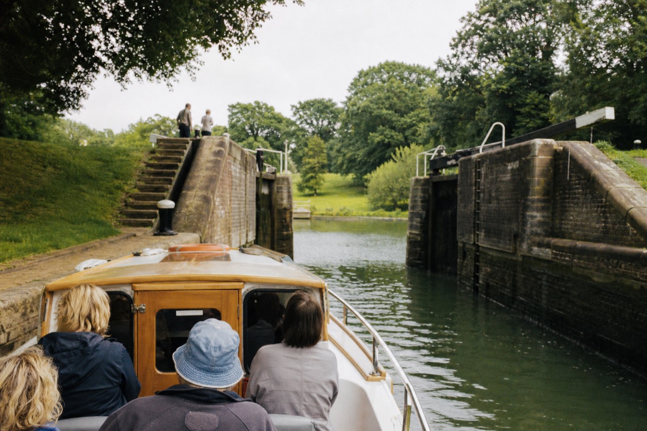 River boat on a green rural stretch of the Thames near Windsor