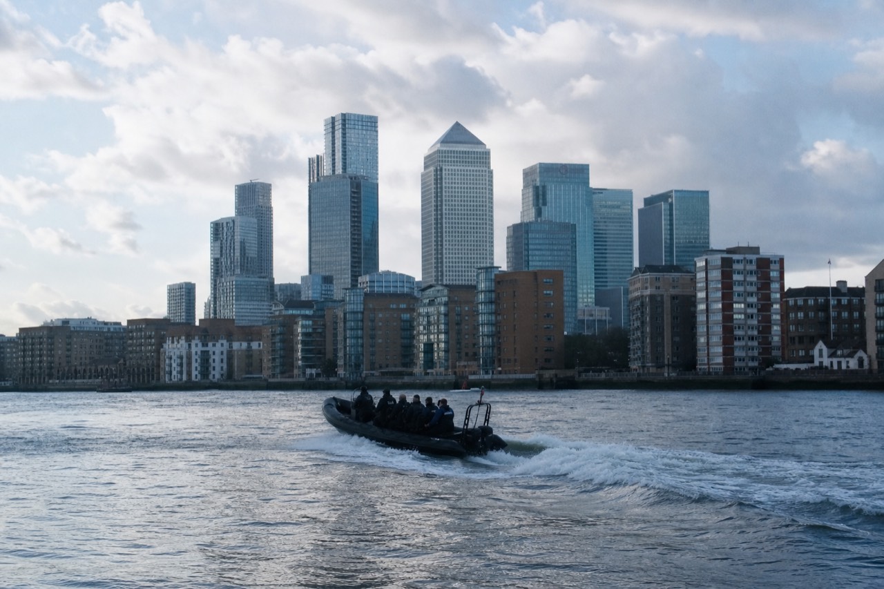 RIB speedboat at speed on the Thames with spray off the bow